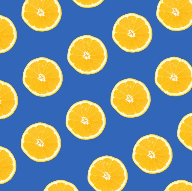 a lot of orange slices laying around in the blue