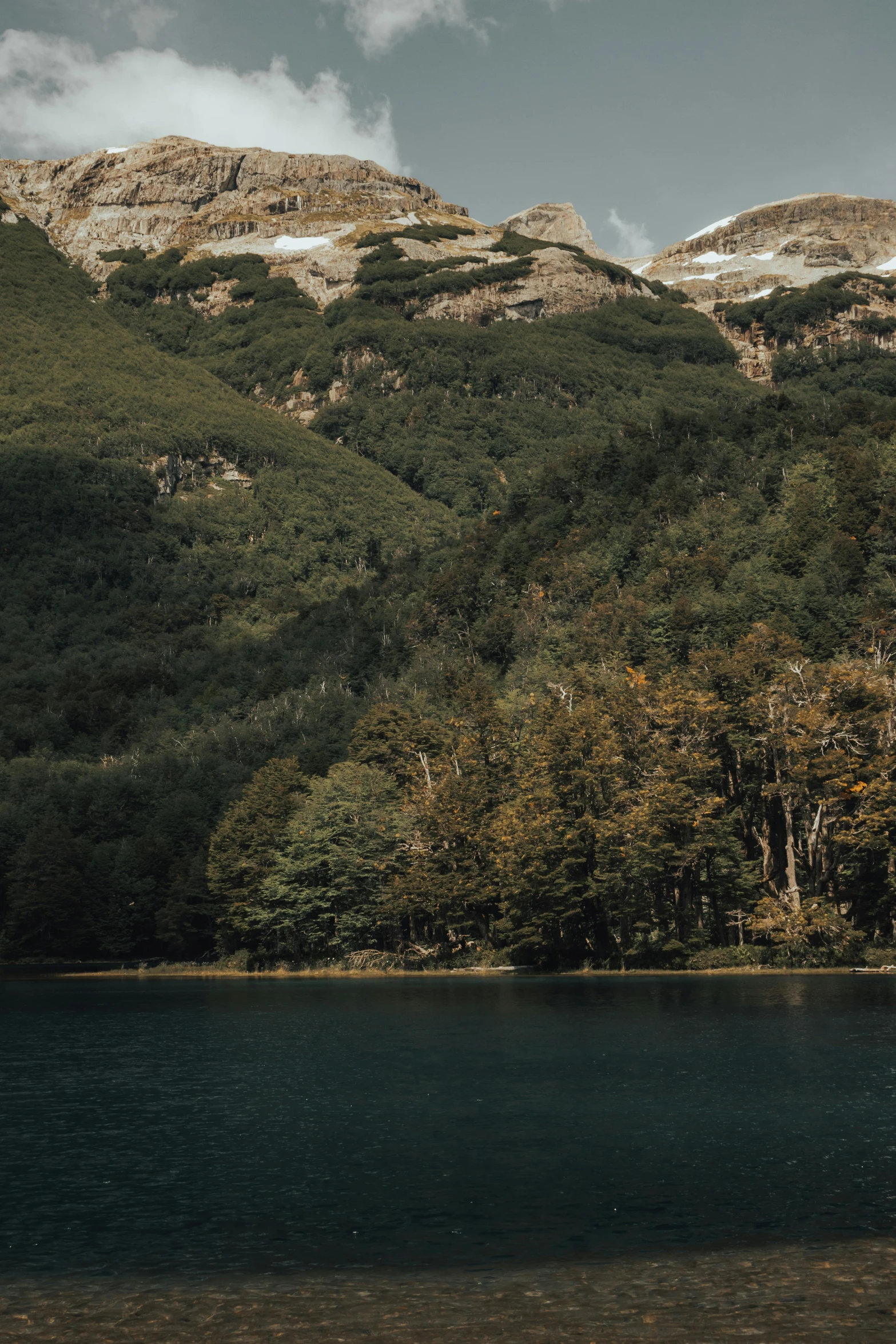 two people kayak in the lake near the mountains