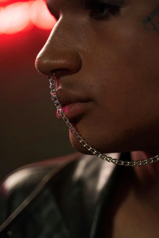 a woman wearing chain around her neck with eyes closed