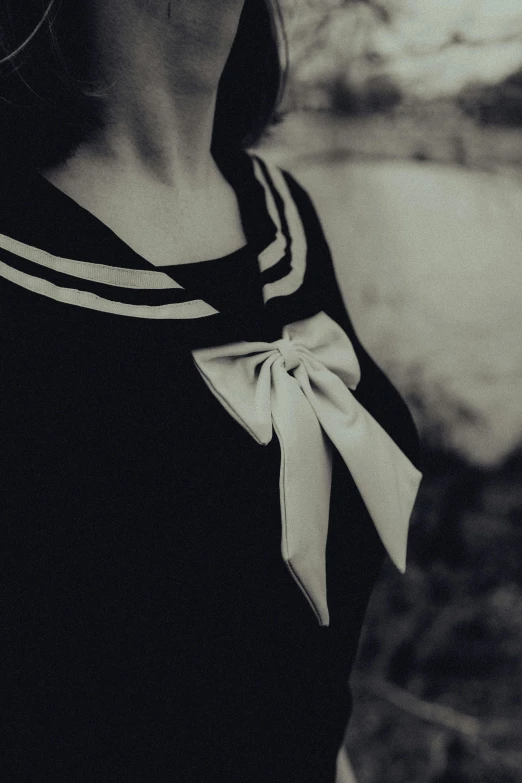 a woman in black with white stripes on her shirt