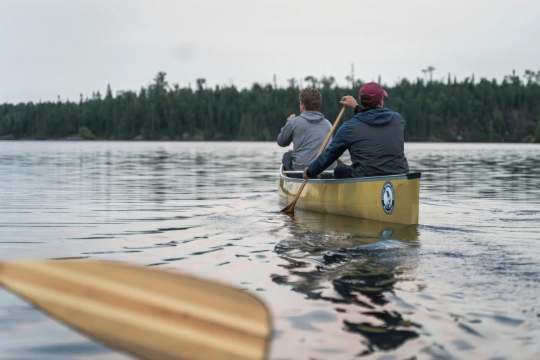 two people in the water on a canoe