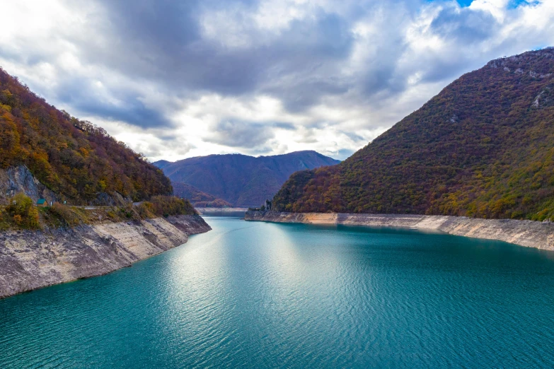 a river is seen in a large mountain valley