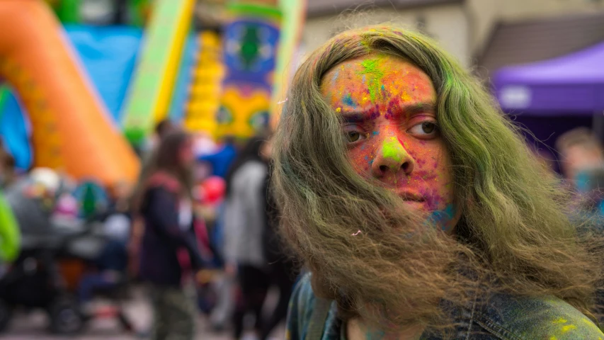 man with painted body and long hair at an inflatable blowup party