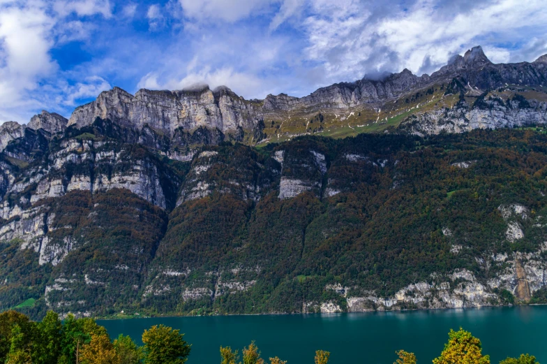 there are mountain sides with trees on either side