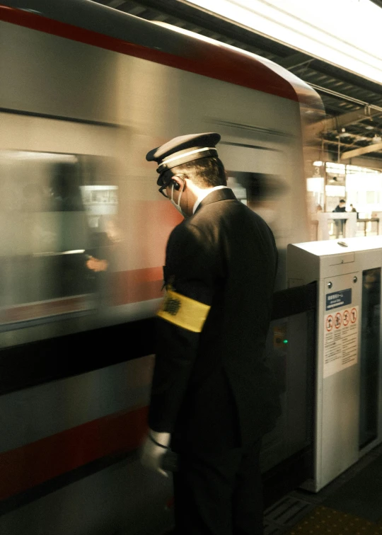 a person in a train station standing near the door