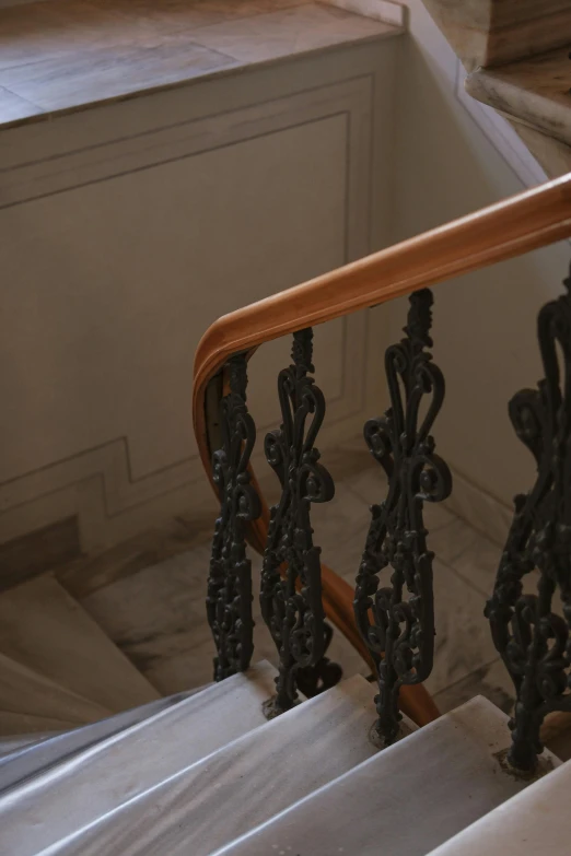 a stairwell with an iron handrail next to the steps