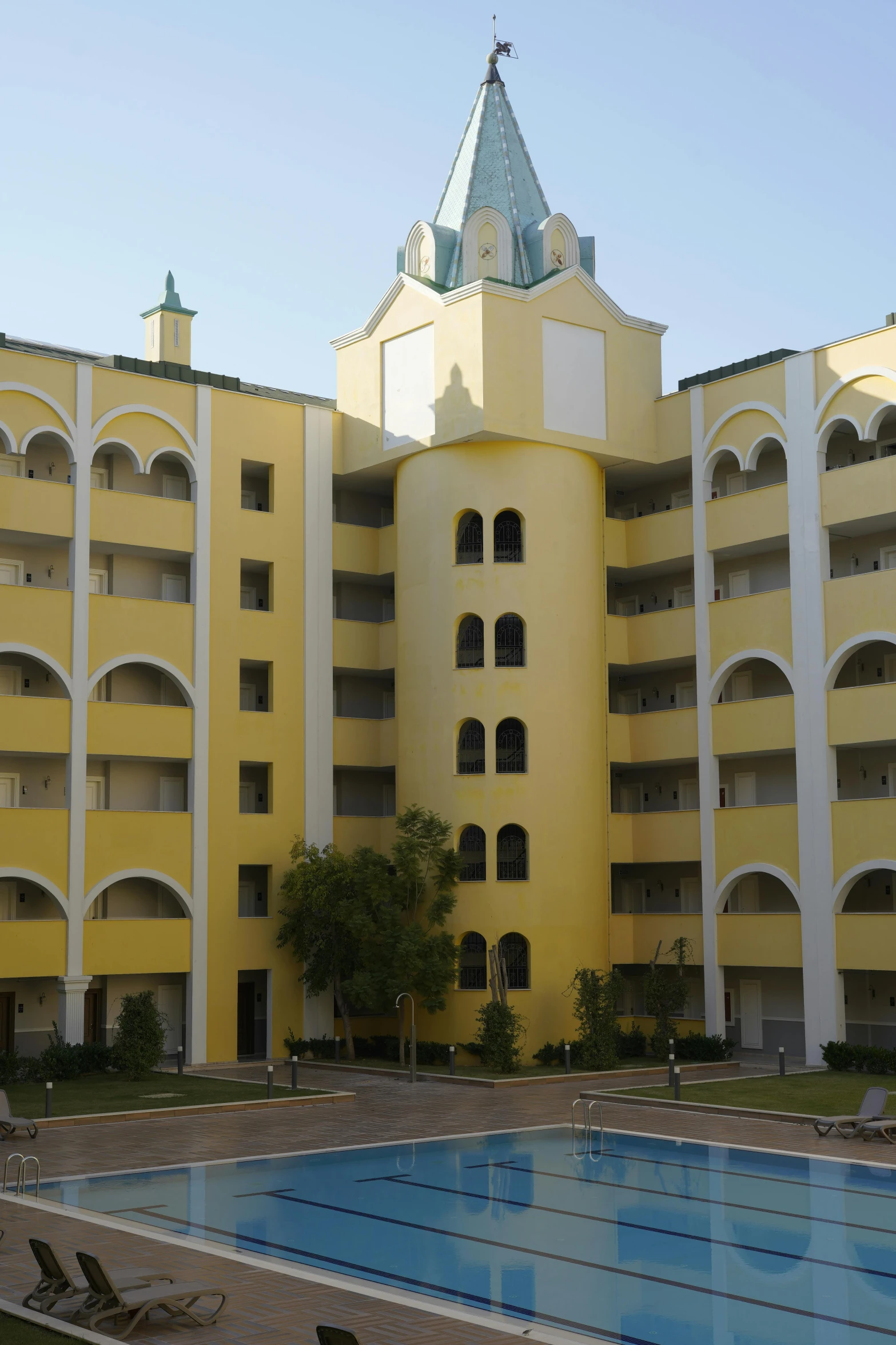 a large building with a swimming pool in the foreground