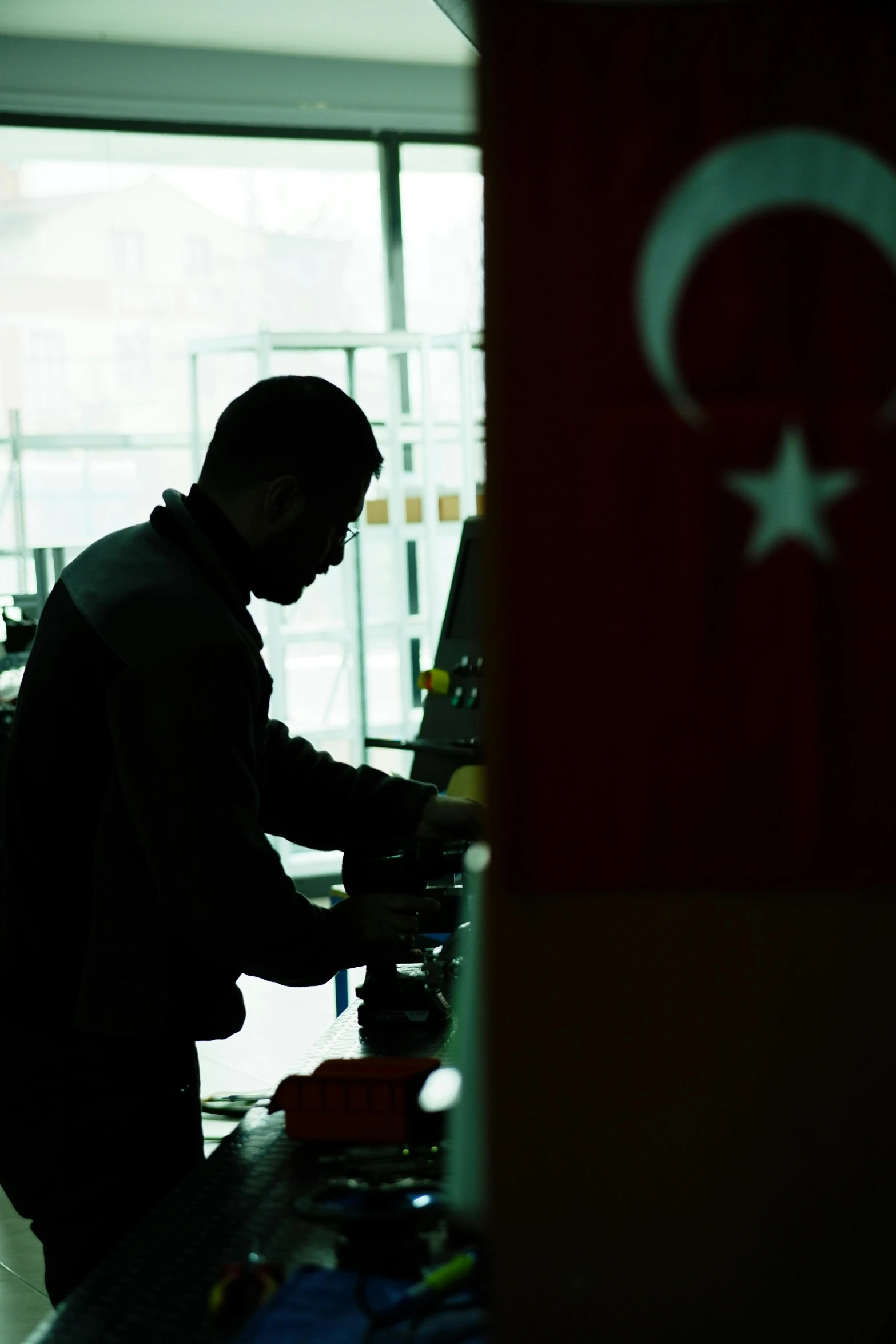 a man is standing at a counter making food