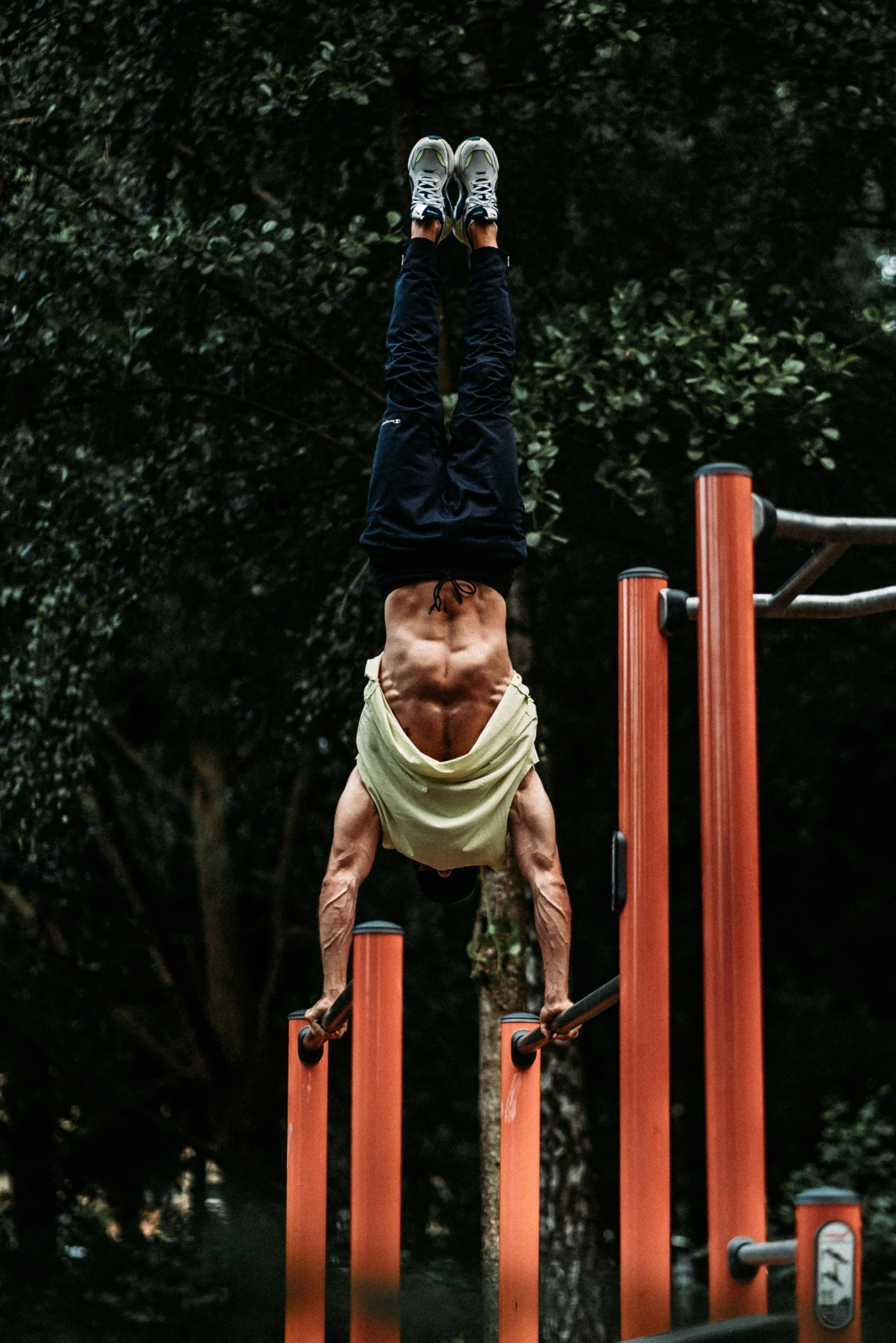 a man doing a hand stand on skis