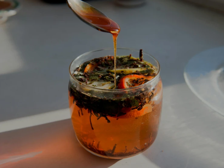 an iced beverage in a glass with strawberries on top