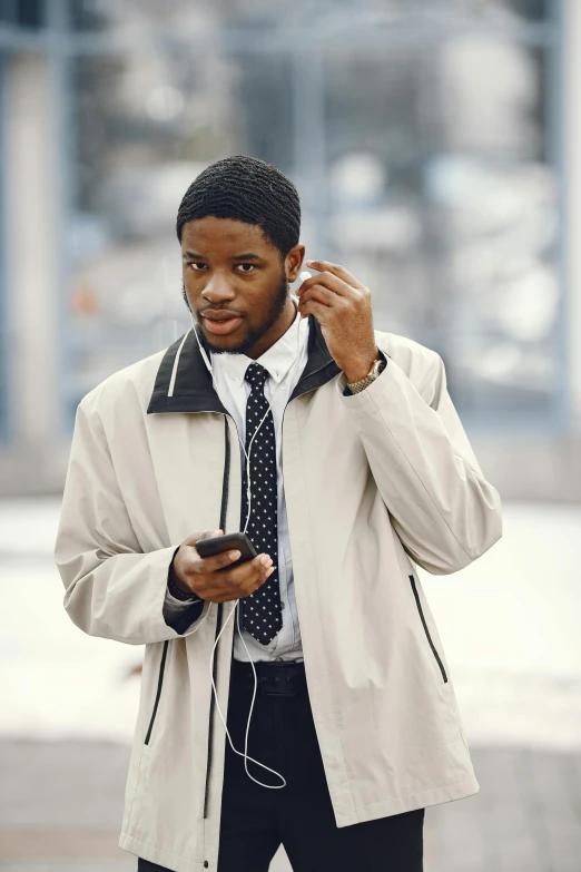 a man on his cell phone is standing by the street