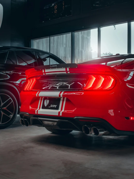 two red sports cars in a dark room