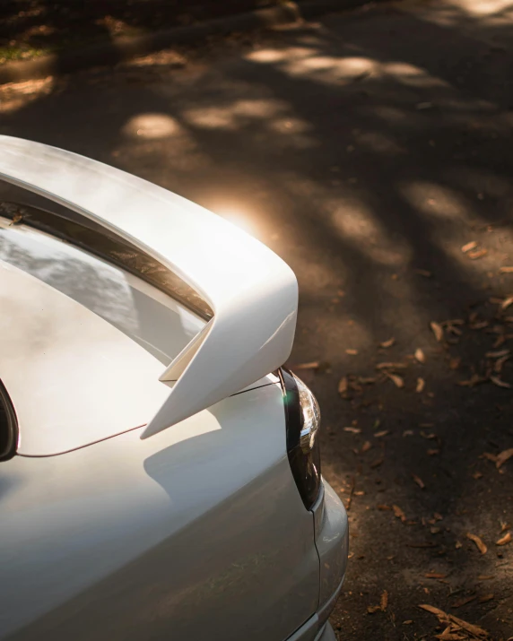 a white car is parked near a street