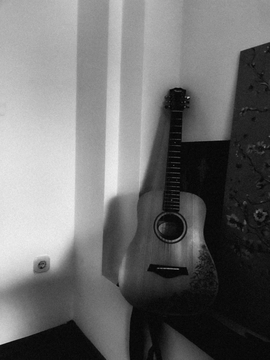 a guitar is next to a wall with a mirror