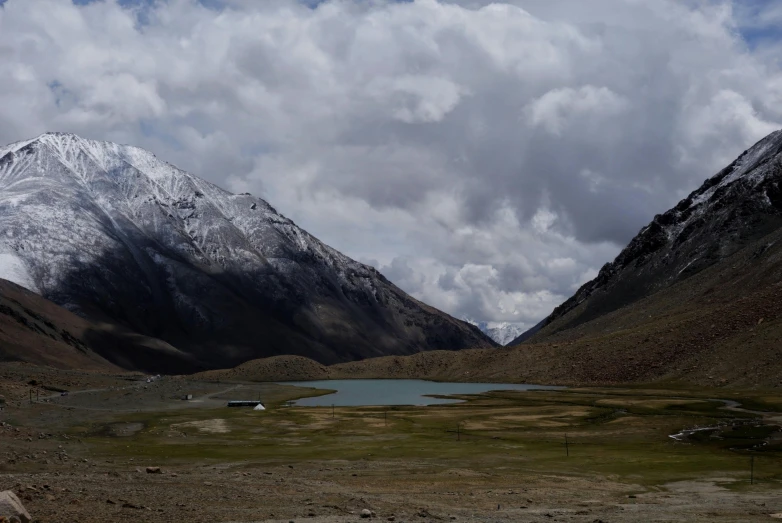 two mountains in the background with a lake in the foreground