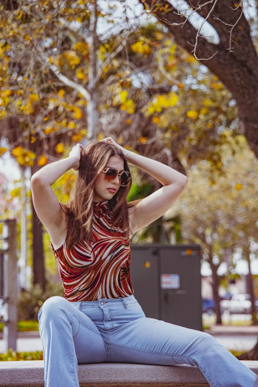 a beautiful young lady sitting on top of a wooden bench