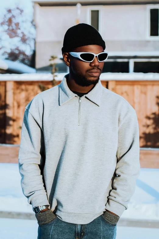 a black man wearing sunglasses and standing outside