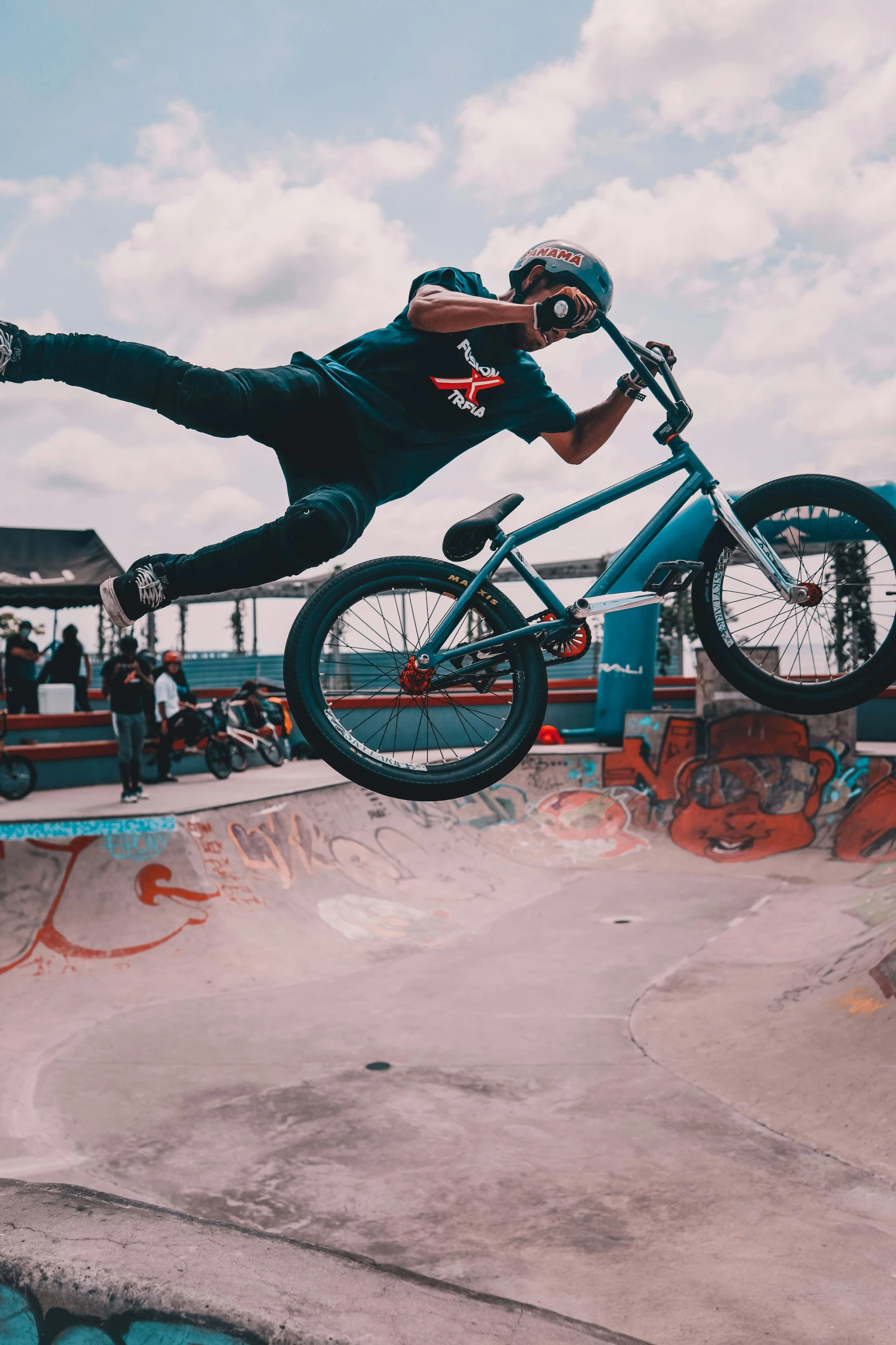 a man on a bike jumping over a pool