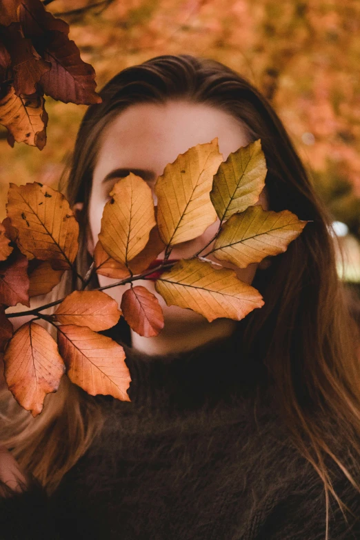 a woman with leaf over her face