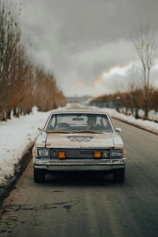 a car driving on the road during the winter