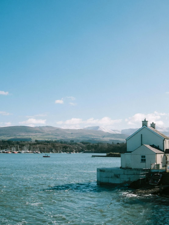 a body of water with a house and buildings