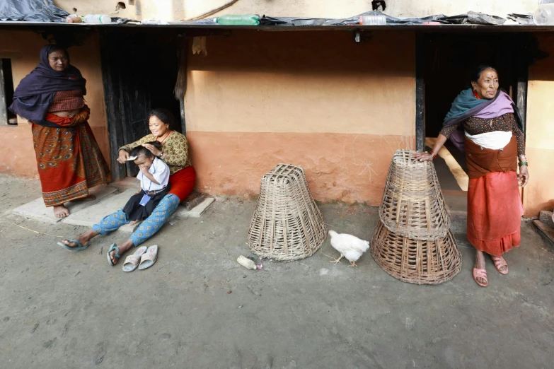 women sitting around with their luggage on the ground