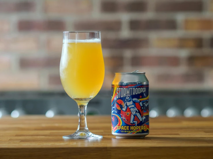 a beer next to a small glass on a table