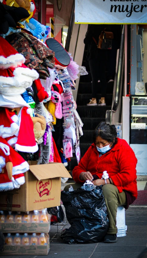 the person in the red jacket is looking at her phone