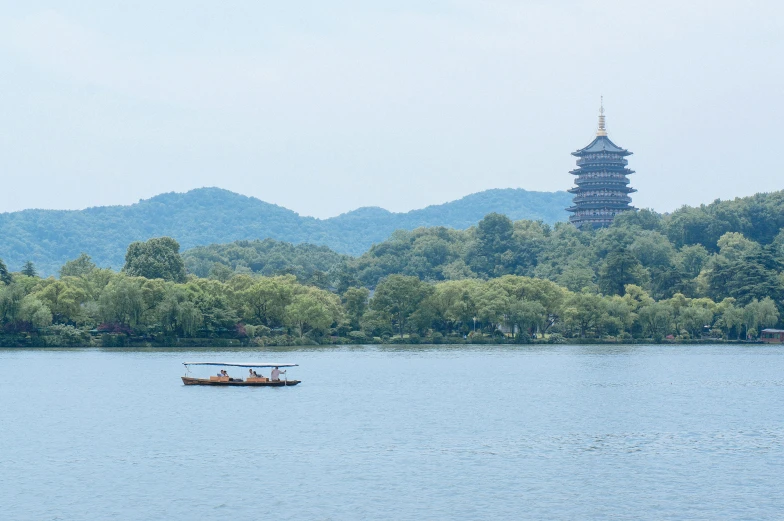 the boat is on the water near mountains