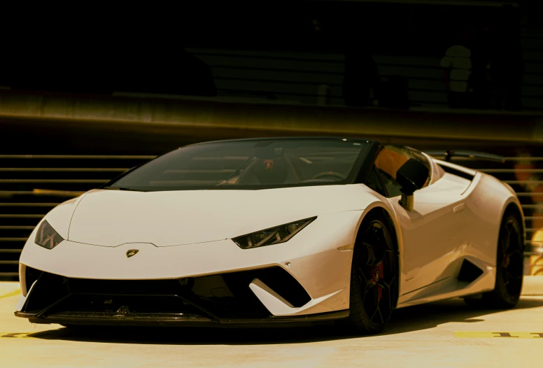 a white lambach parked outside of a garage