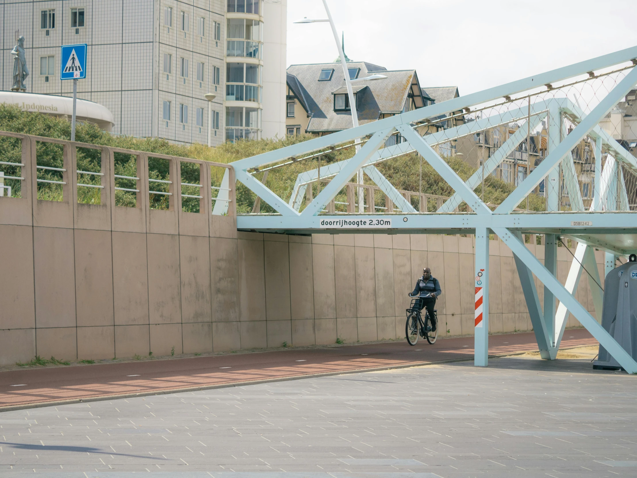 a man rides his bicycle down an elevated road