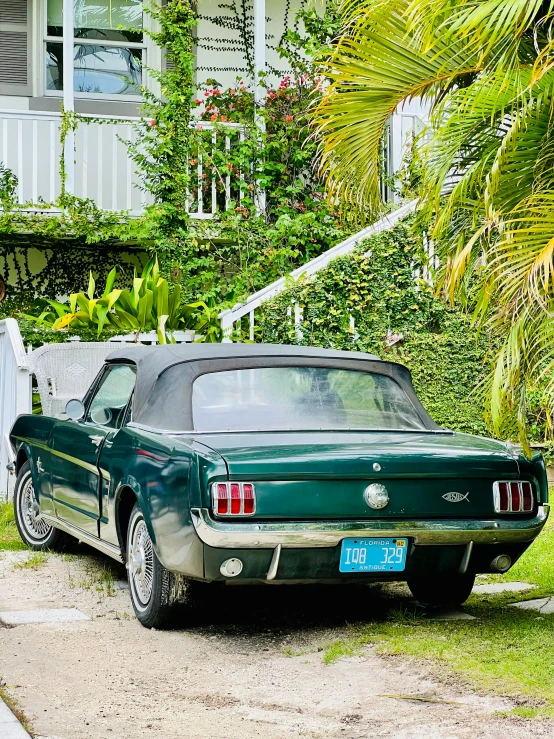 a car parked in a driveway next to some grass