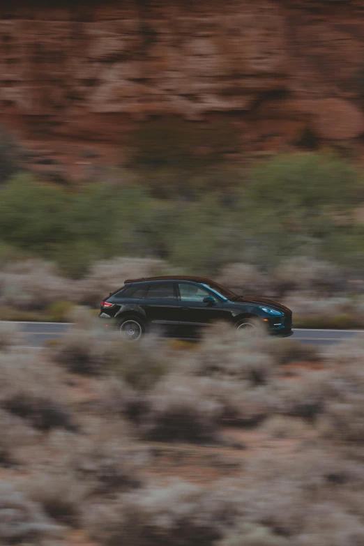 a car driving down a street in the desert
