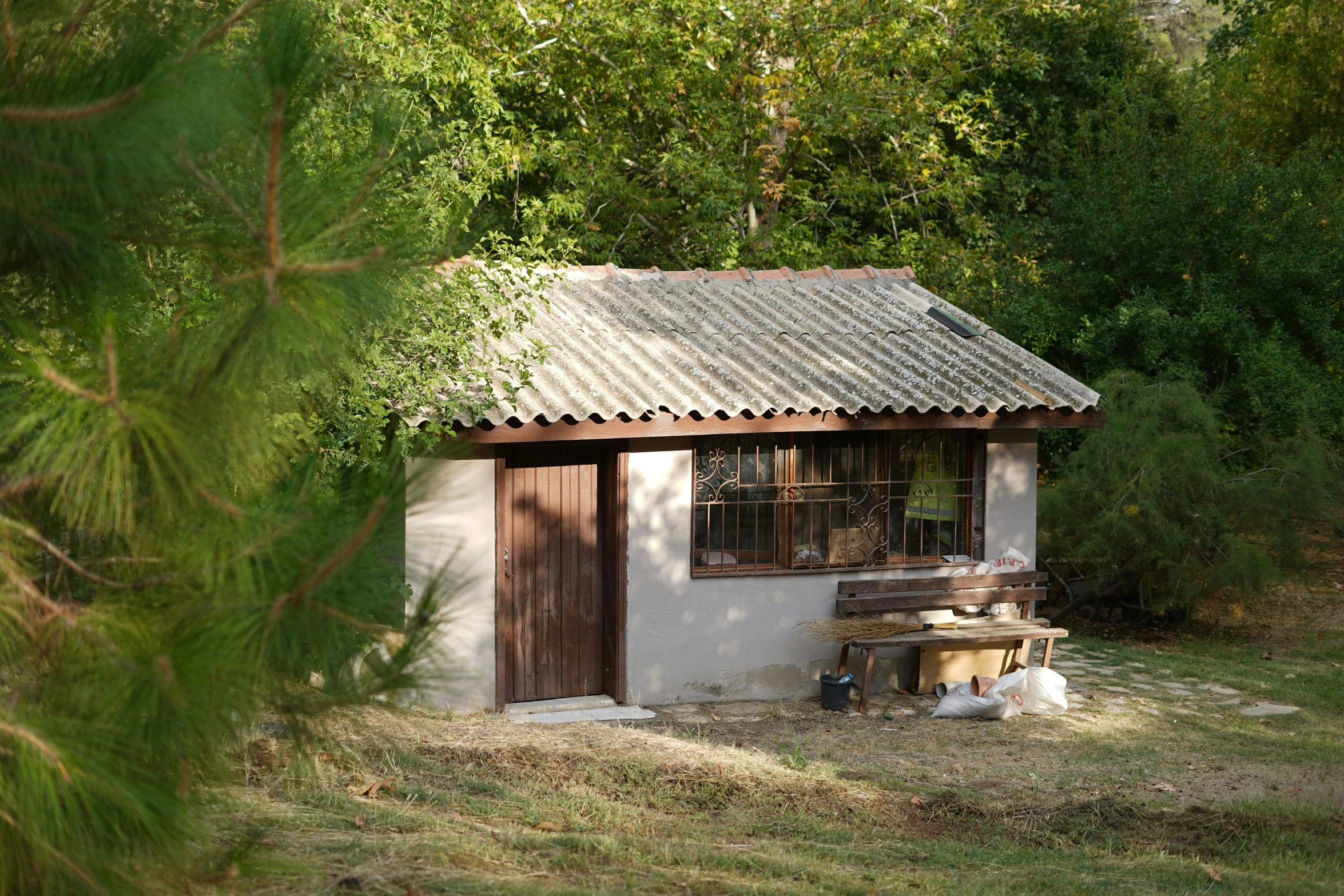 a small building with a door on a field