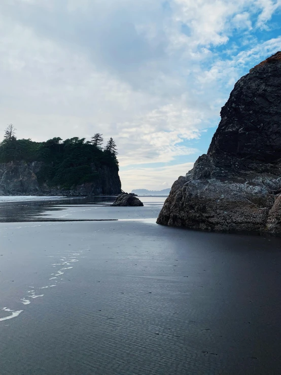 a beach that is covered in sand near the water