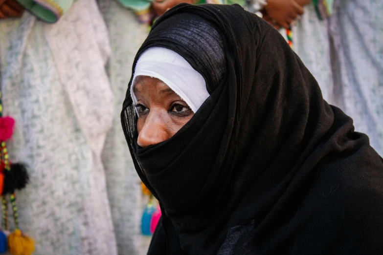 a woman in the middle of the street wearing a headscarf