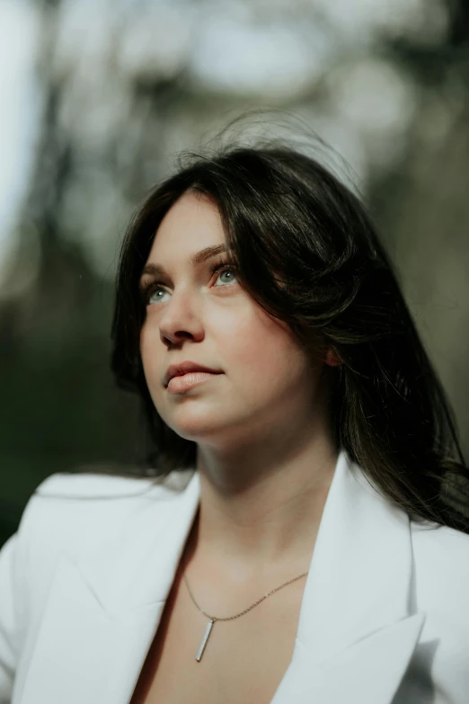 a young woman with long hair wearing a white jacket