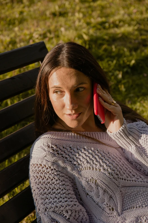 a woman holding a cell phone up to her ear