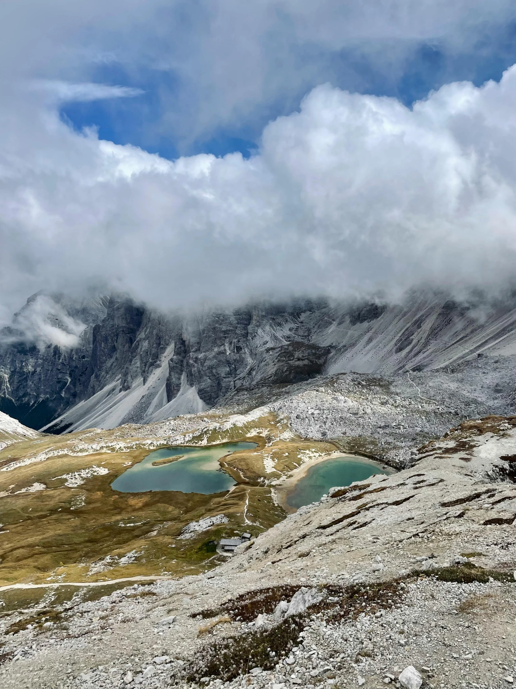 the mountains are covered in snow and clouds