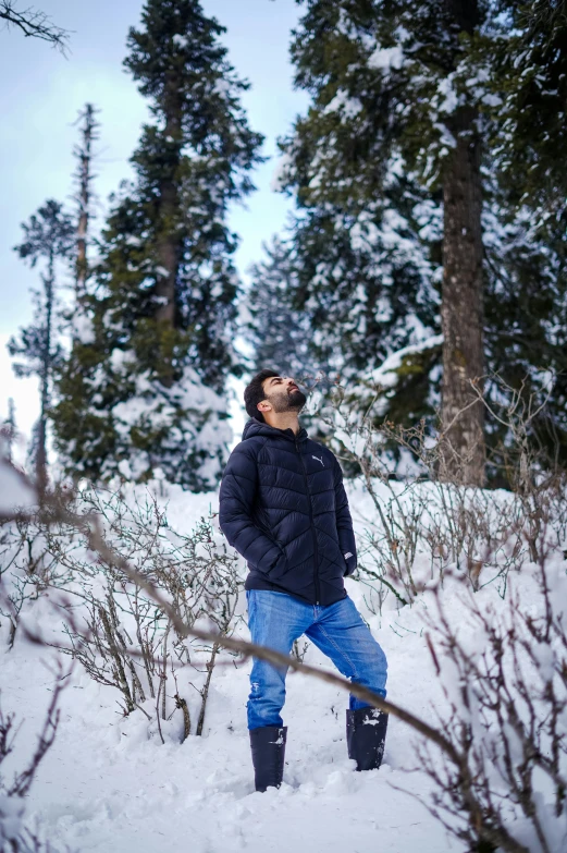 a man is standing in the snow on a hill