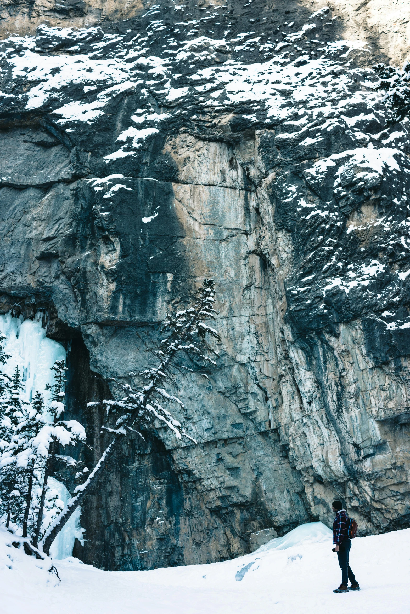 a person standing on snow slope above mountain