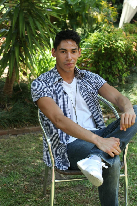 a man wearing headphones sitting in a chair