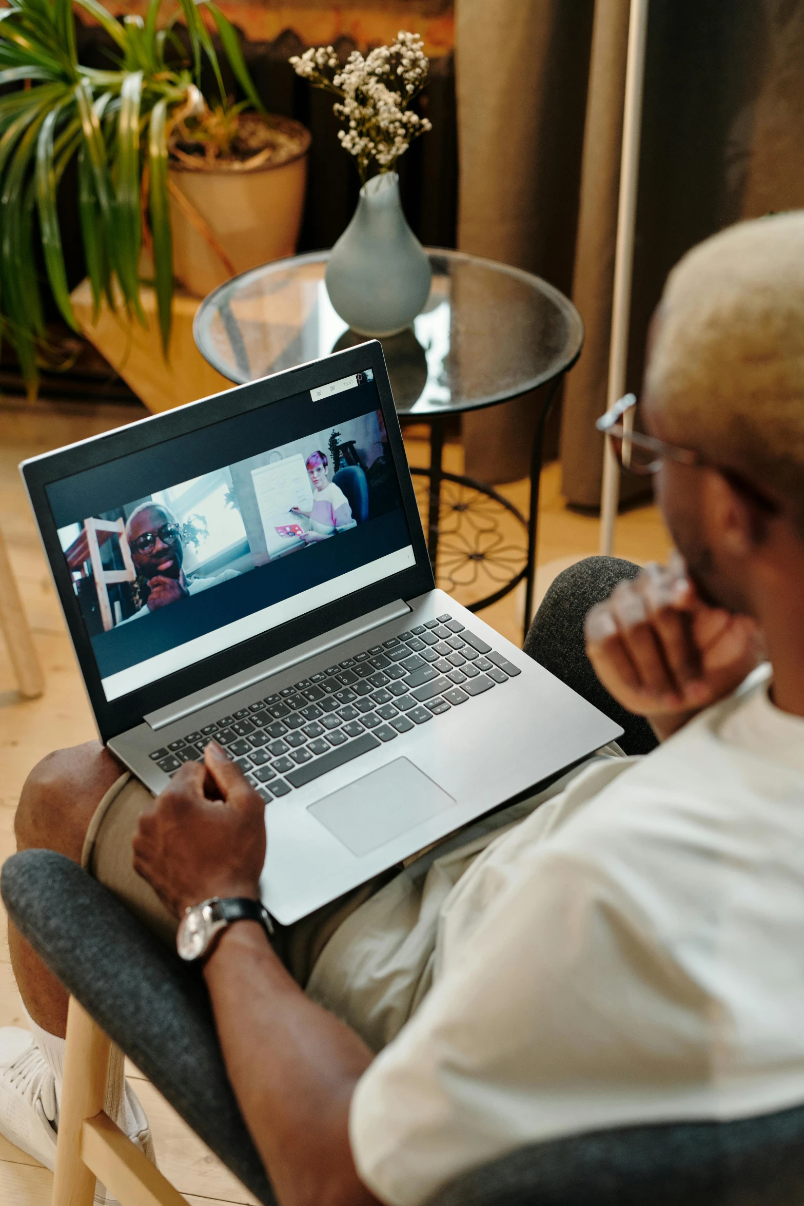 a man on his laptop looking down at the screen