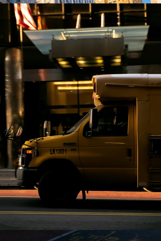 a yellow truck that is driving down the road