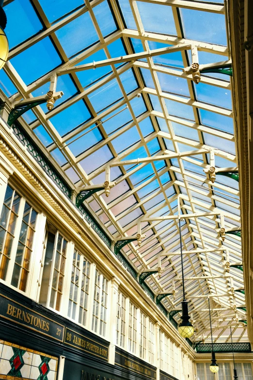 a train platform at a train station with clear glass ceiling