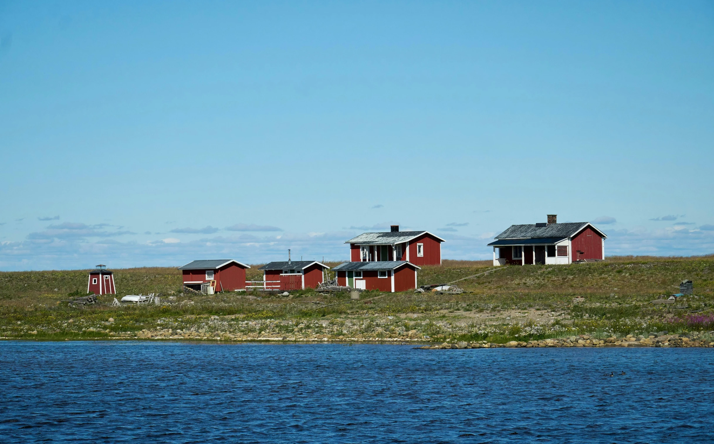 two red houses that are next to water