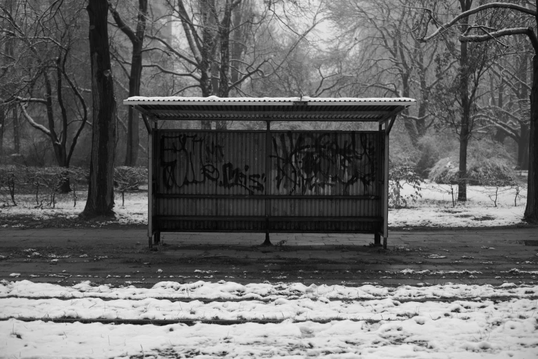 a bench with writing on it sitting in the snow