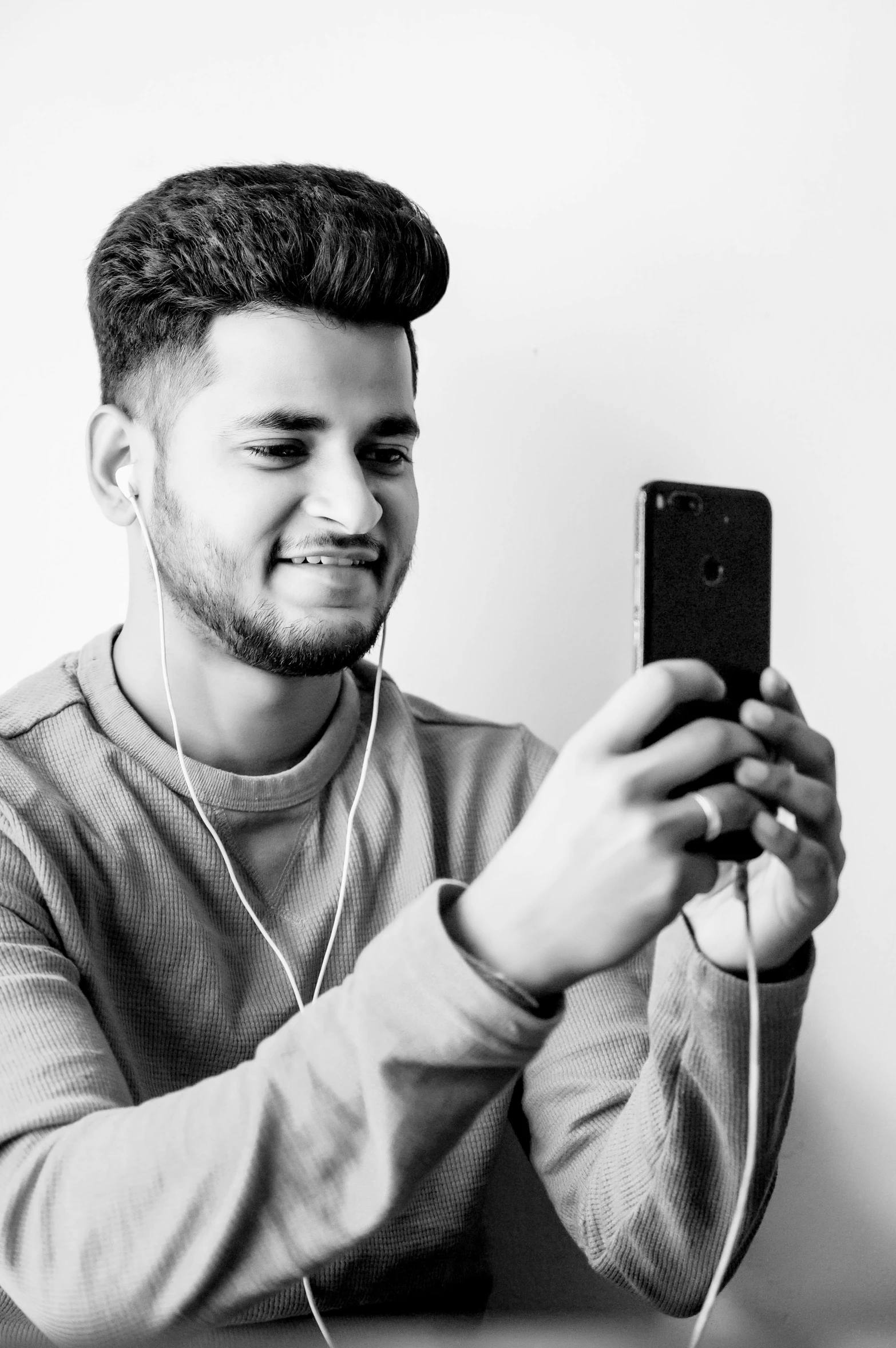 an image of a man smiling and holding up his phone