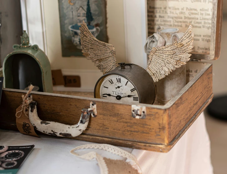 an empty box with several clocks and other antique items