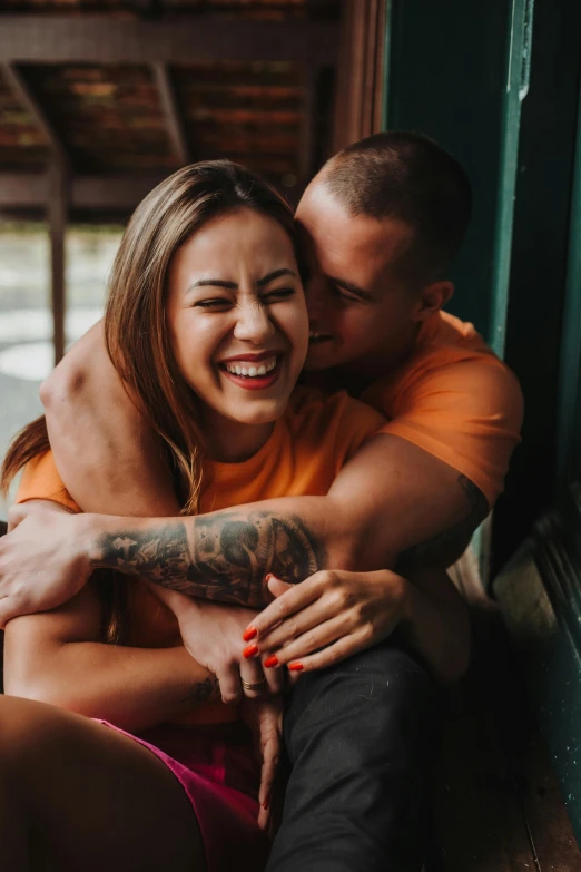 a man hugging a woman in the background with his eyes closed